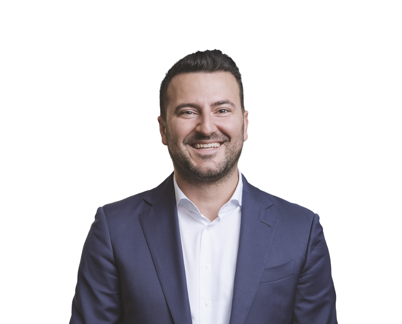 Smiling man with dark hair and a beard wearing a blue blazer and a white shirt.